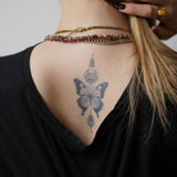 Vlinder met symbolen Tatoeage